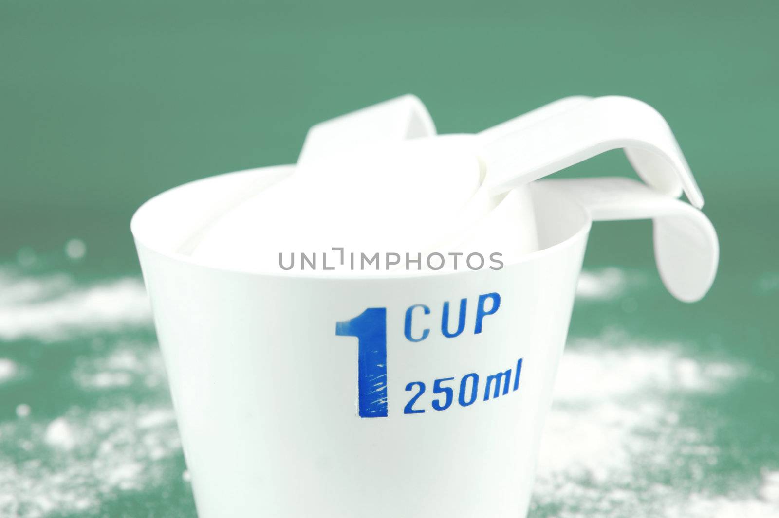 Measuring cups isolated against a green background