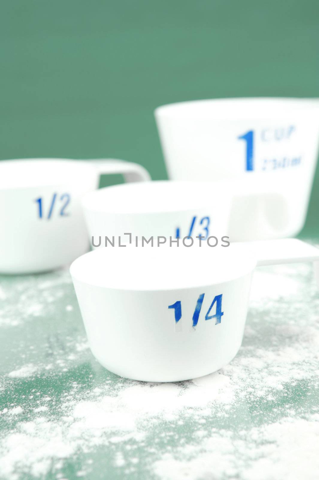 Measuring cups isolated against a green background