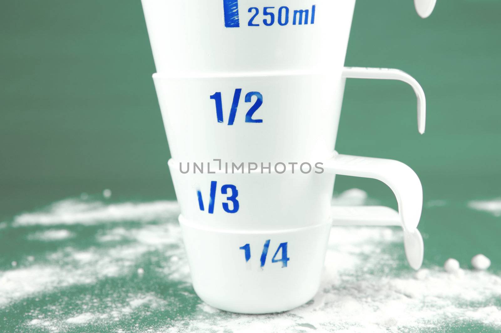 Measuring cups isolated against a green background