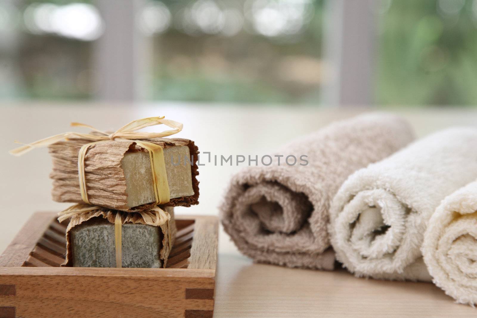 Soaps,towels amd wook basket with a blurred background
