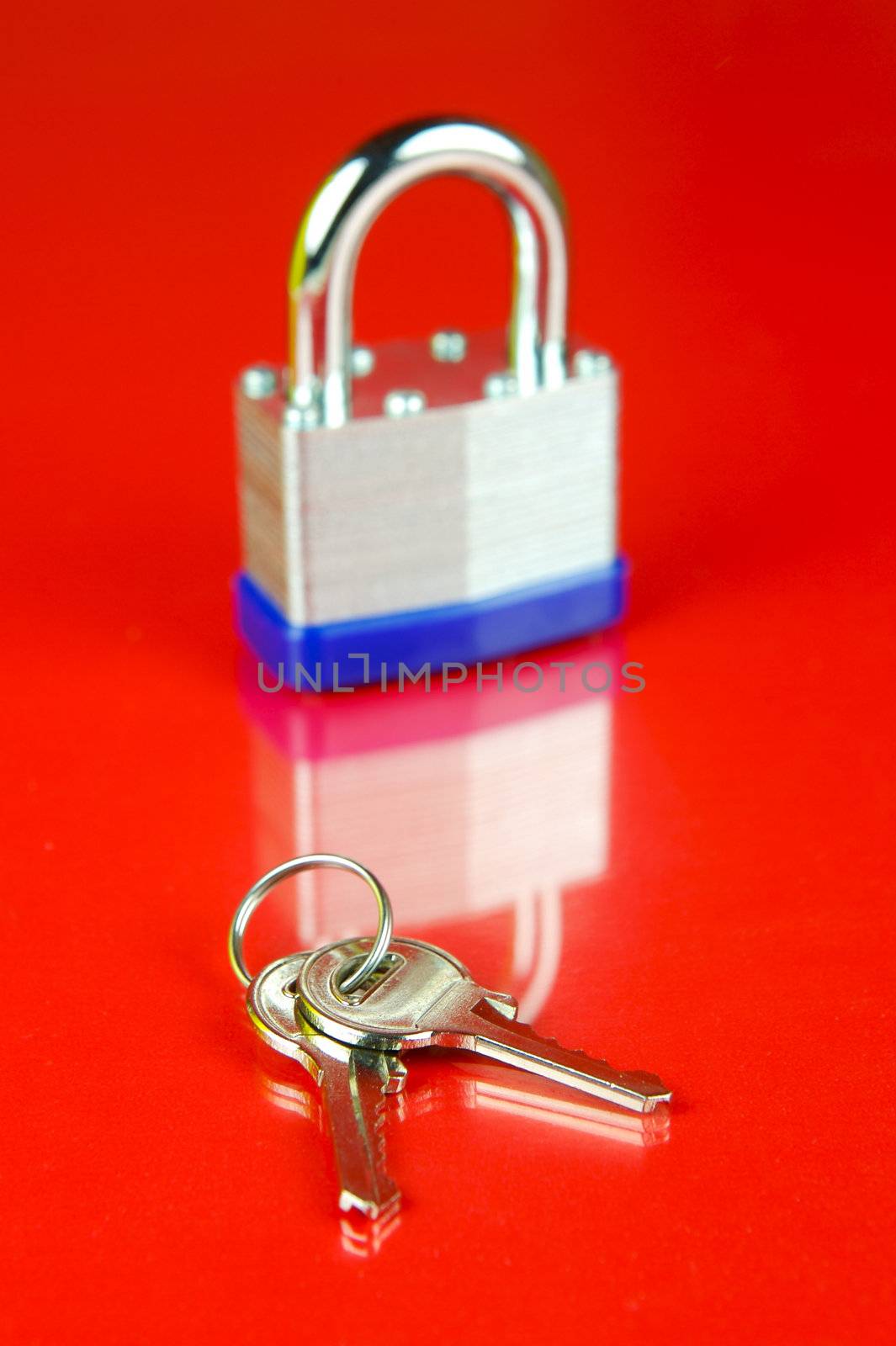 A padlock isolated against a red background