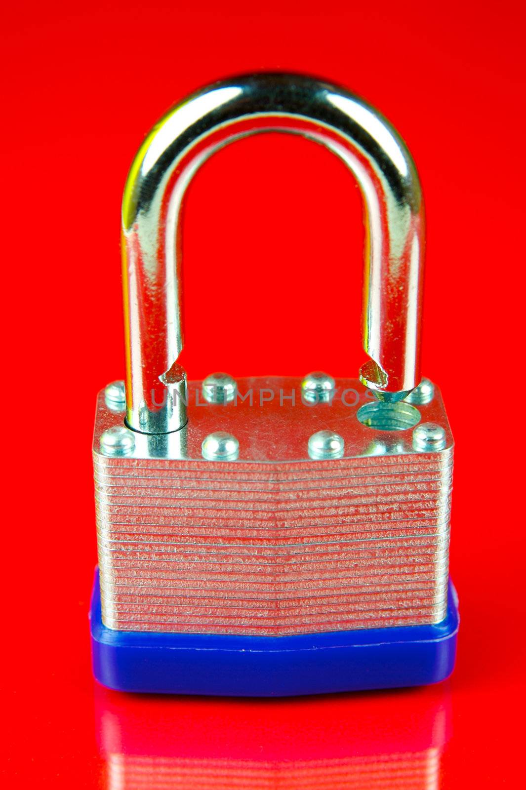 A padlock isolated against a red background