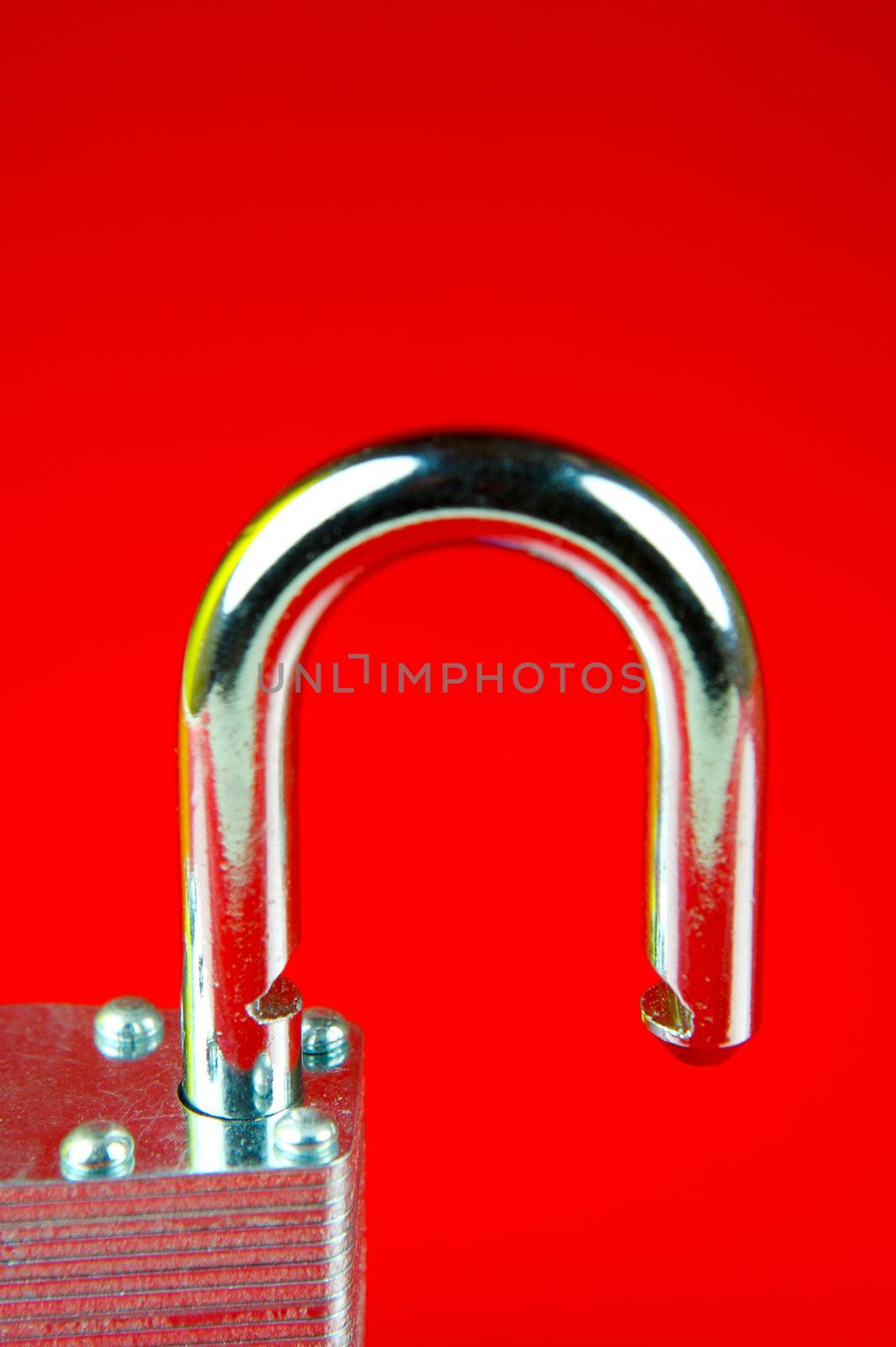 A padlock isolated against a red background