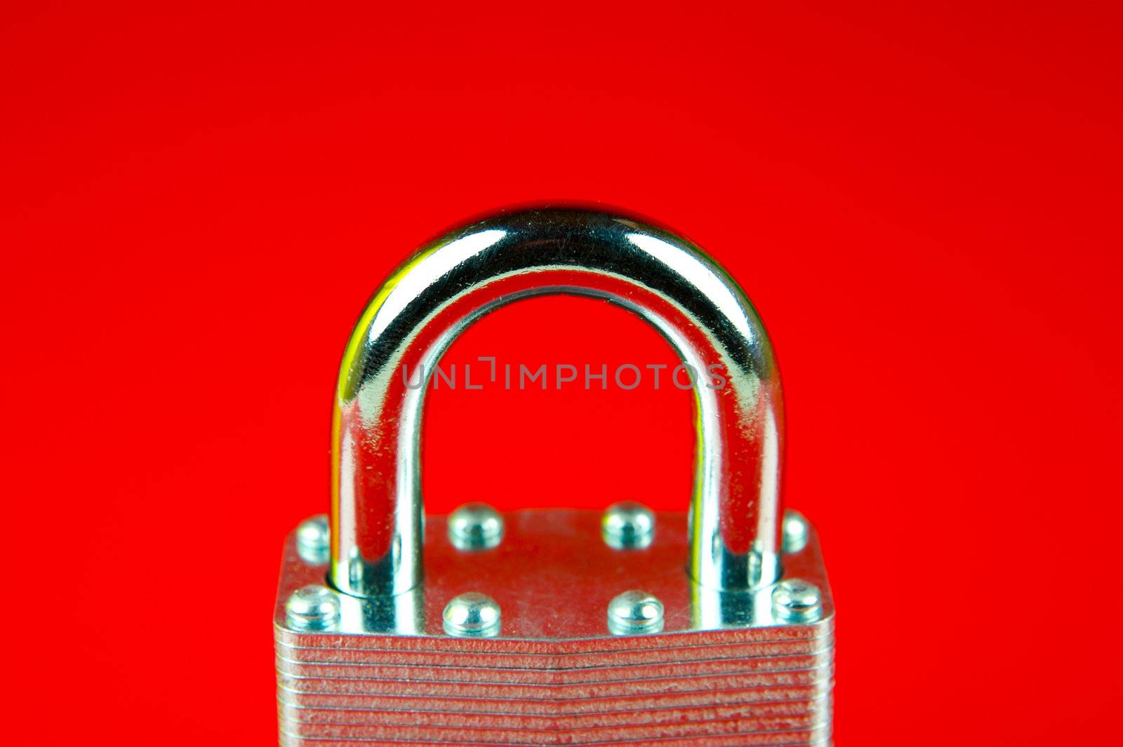 A padlock isolated against a red background