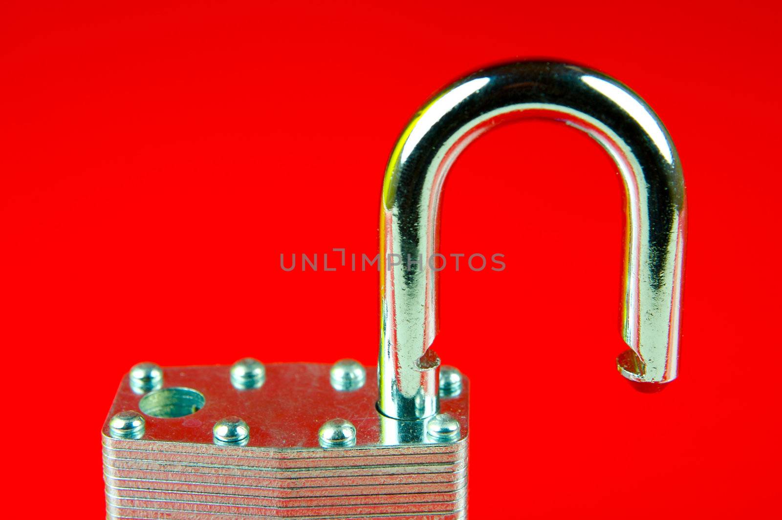 A padlock isolated against a red background