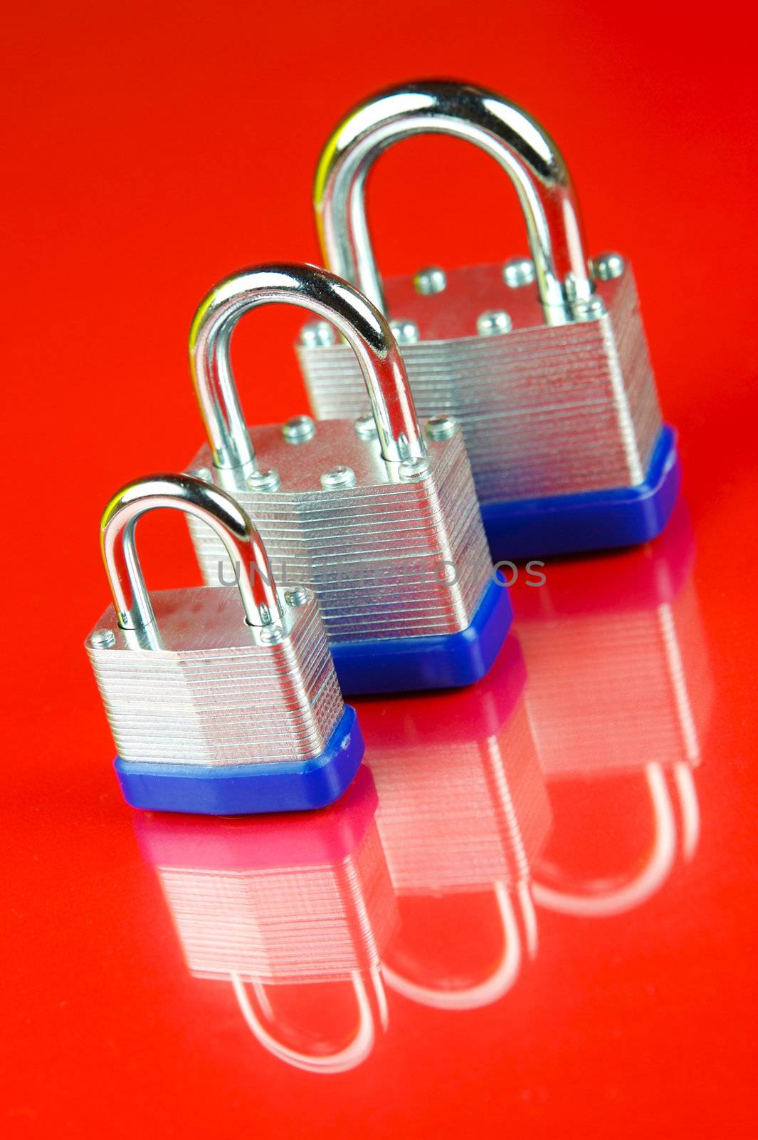 A padlock isolated against a red background