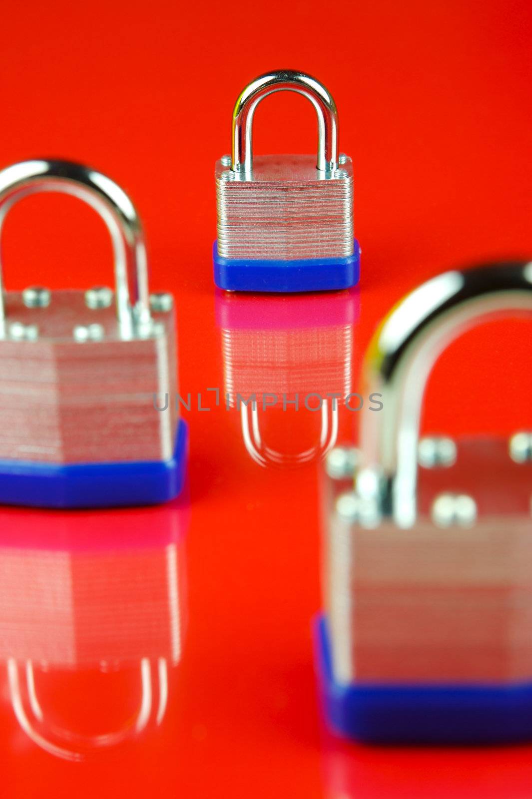 A padlock isolated against a red background