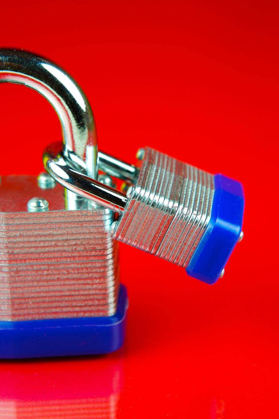 A padlock isolated against a red background