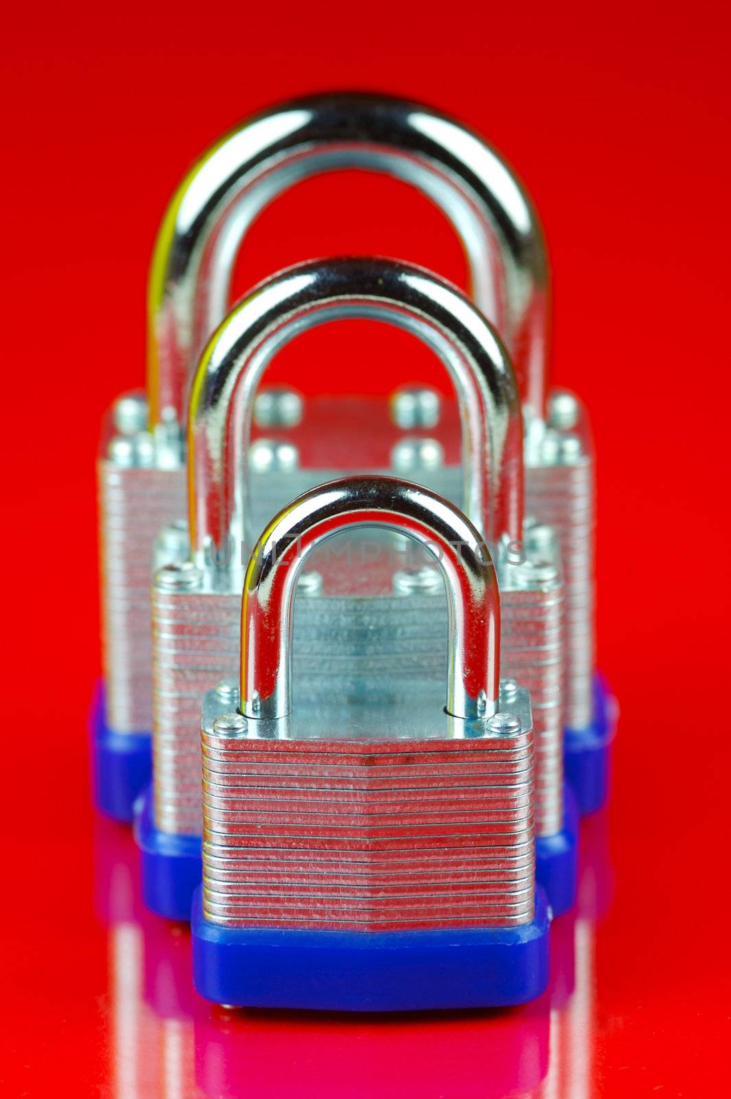 A padlock isolated against a red background