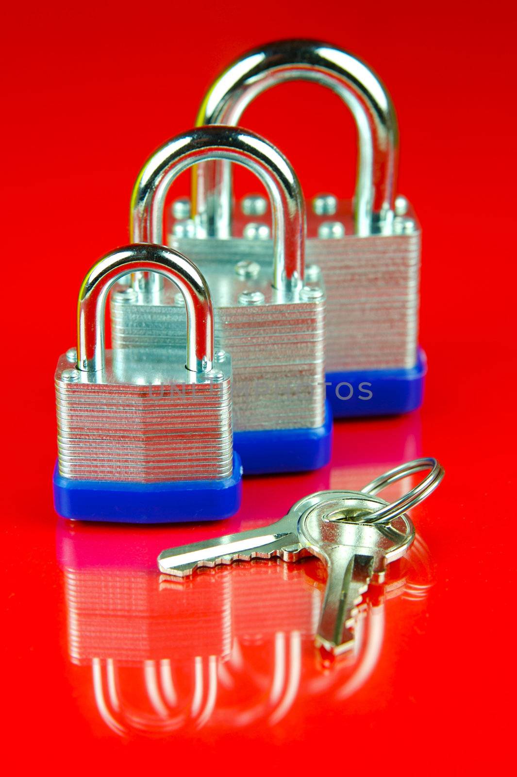 A padlock isolated against a red background