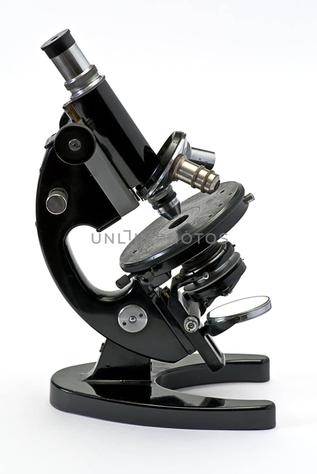 old optical microscope isolated on white