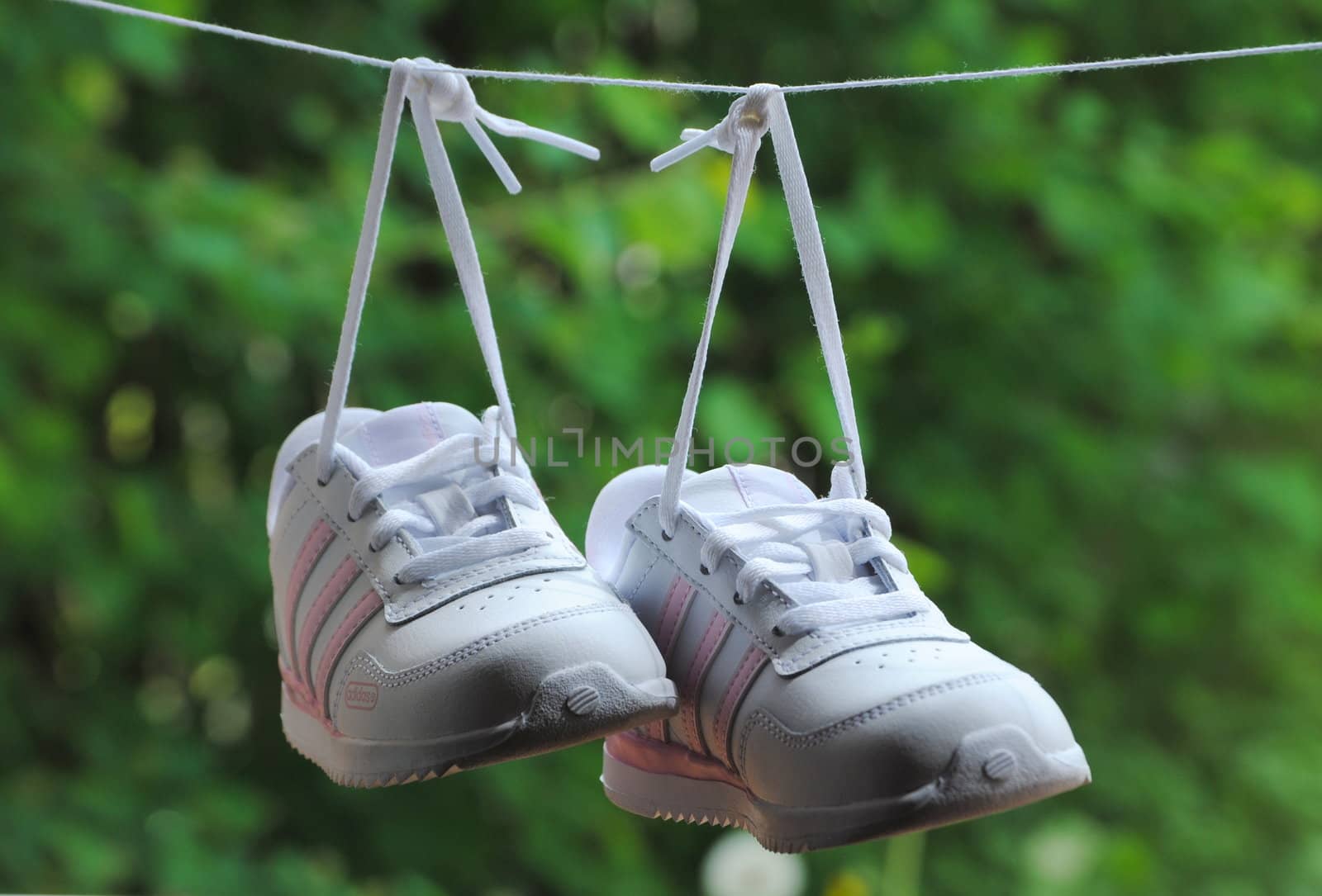 child shoes hanging on wire