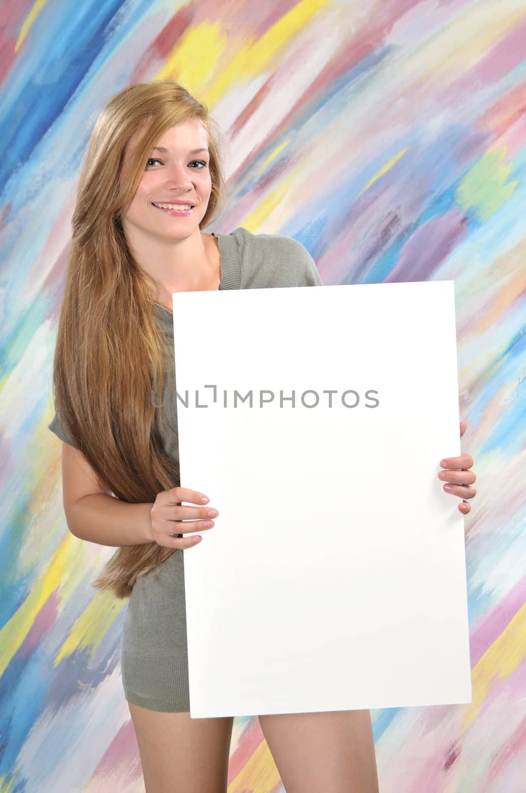 Beautiful blond woman, holding a blank paper for sign advertising 
