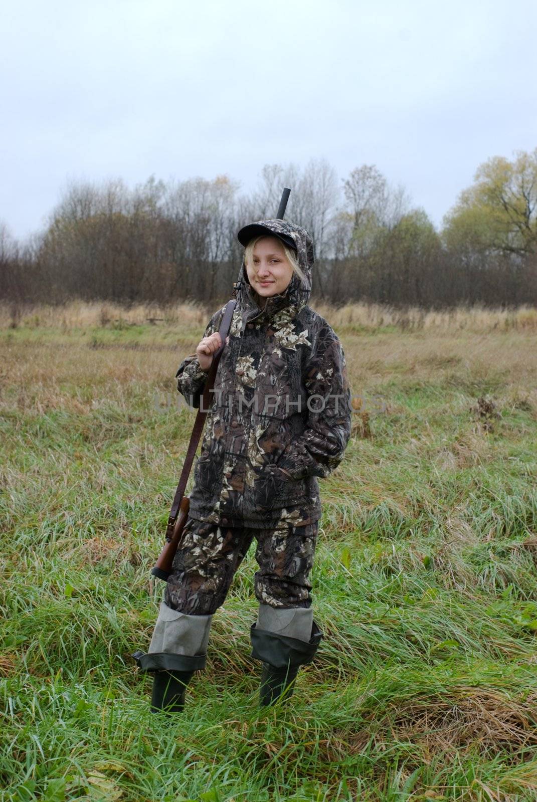 The girl dressed in a camouflage with a gun