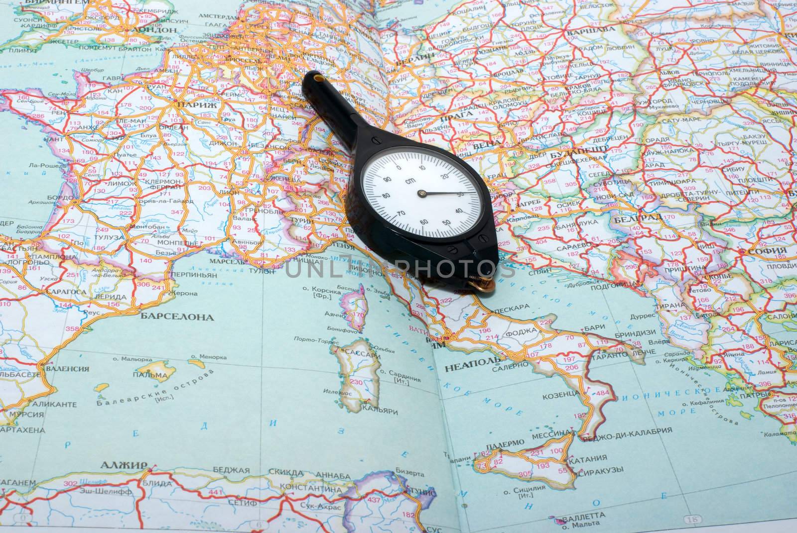 curvimeter on the opened atlas of highways of Europe