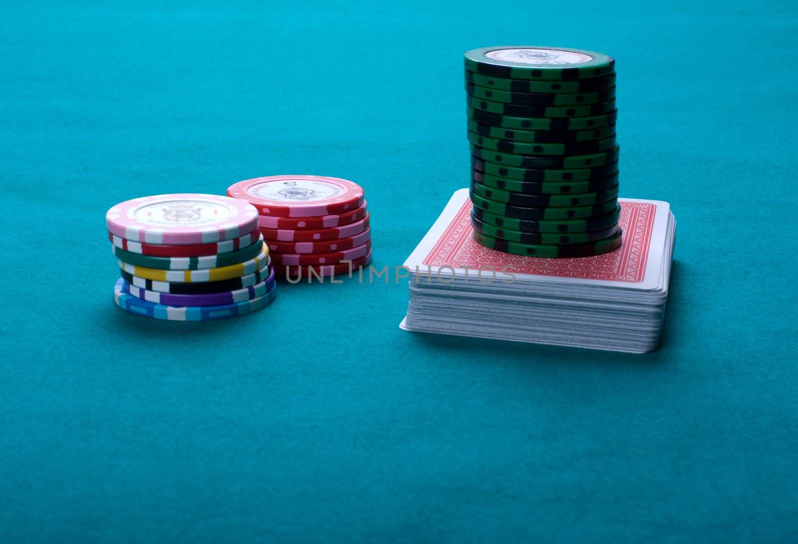 Piles of counters and a pack on green cloth