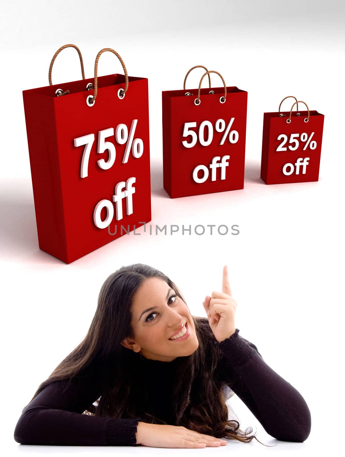 laying young woman pointing at the 
three dimensional shopping bags