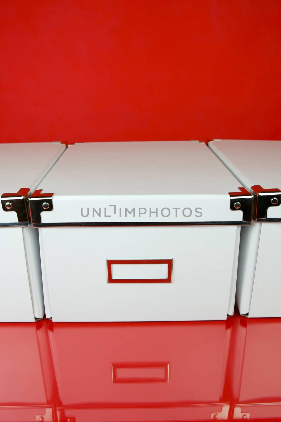 Storage boxes isolated against a red background