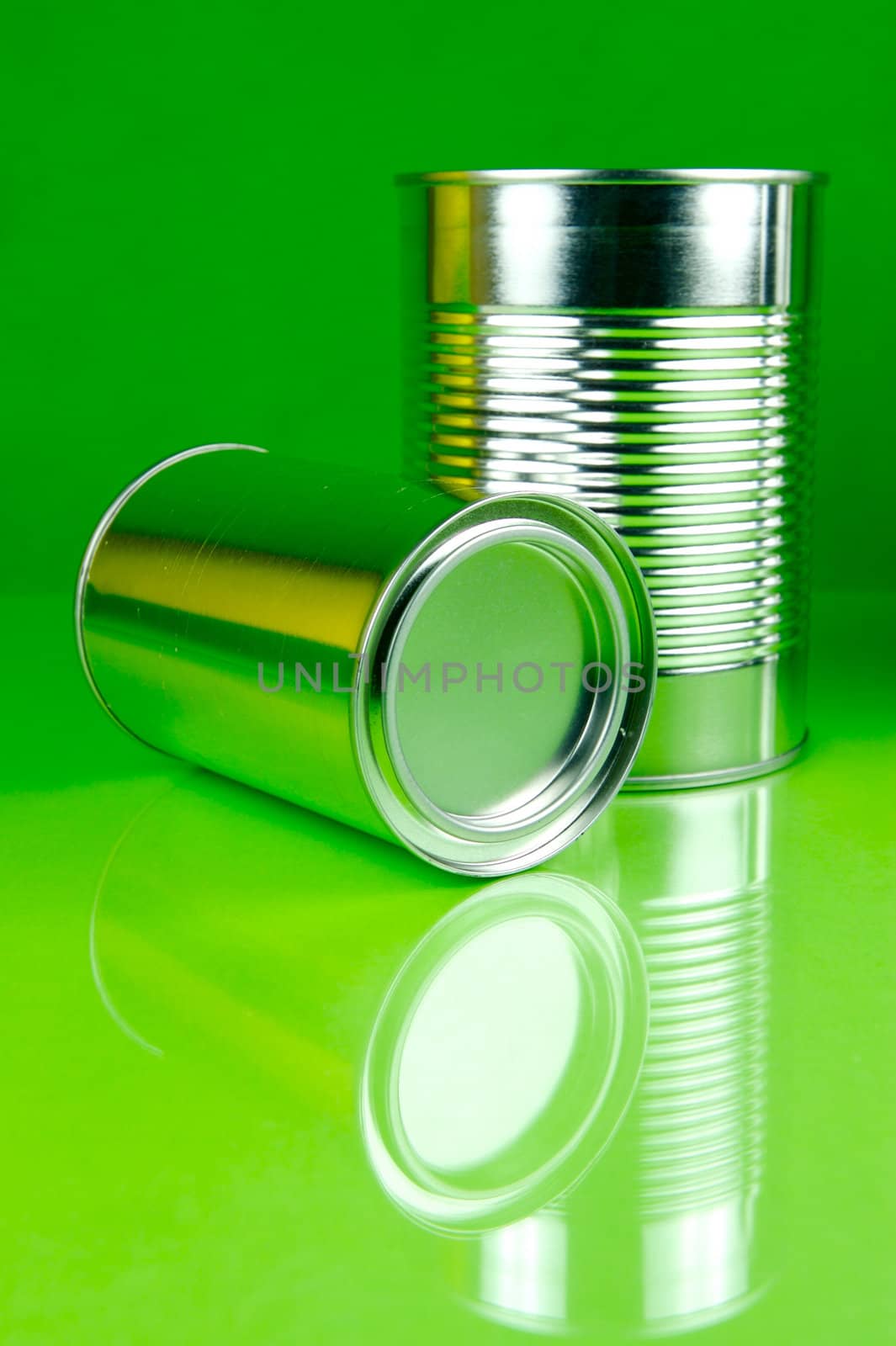 Storage tins isolated against a green background