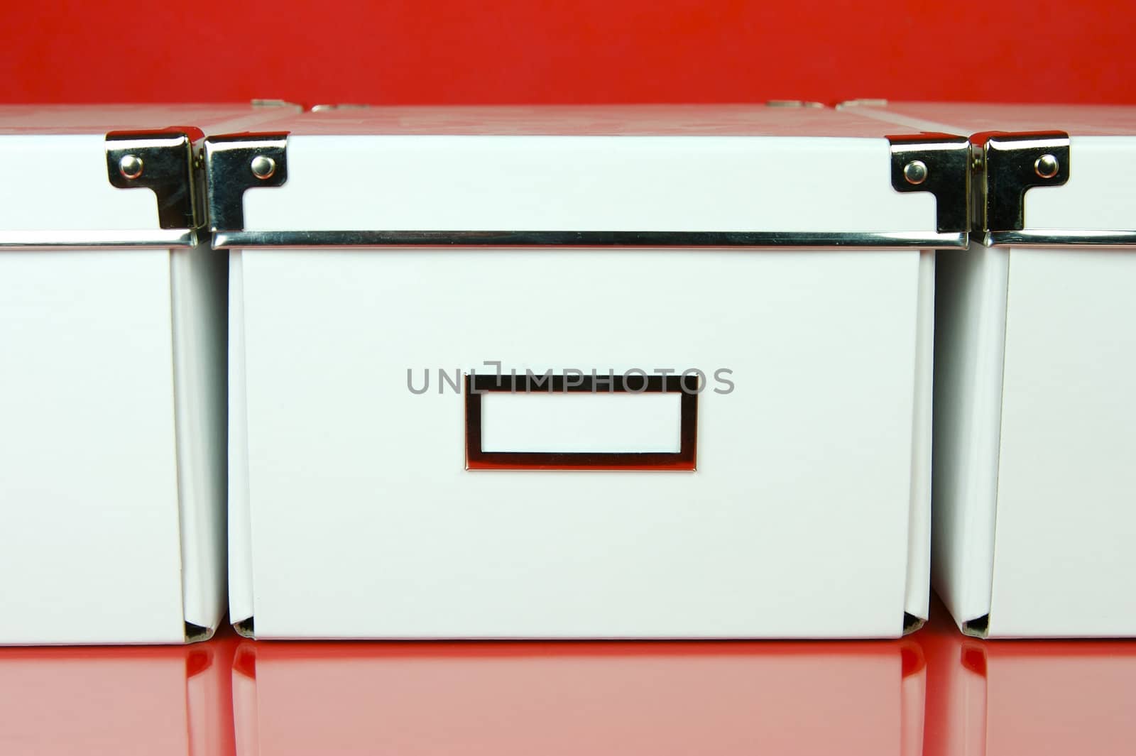 Storage boxes isolated against a red background