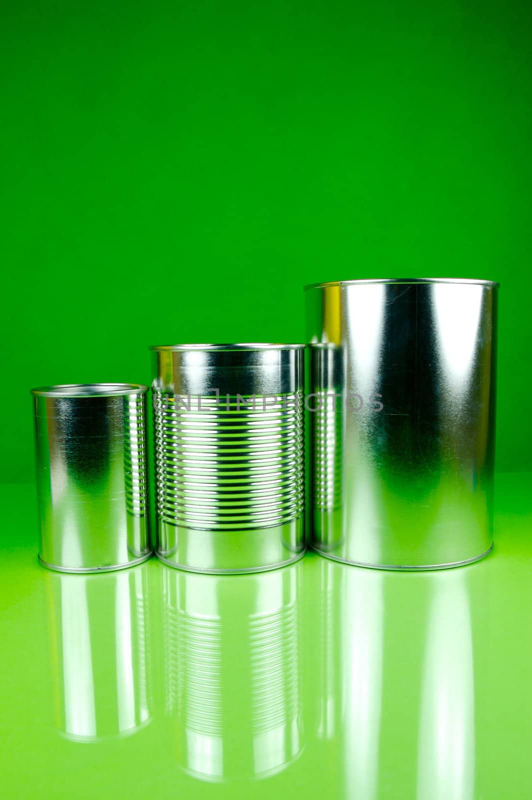 Storage tins isolated against a green background