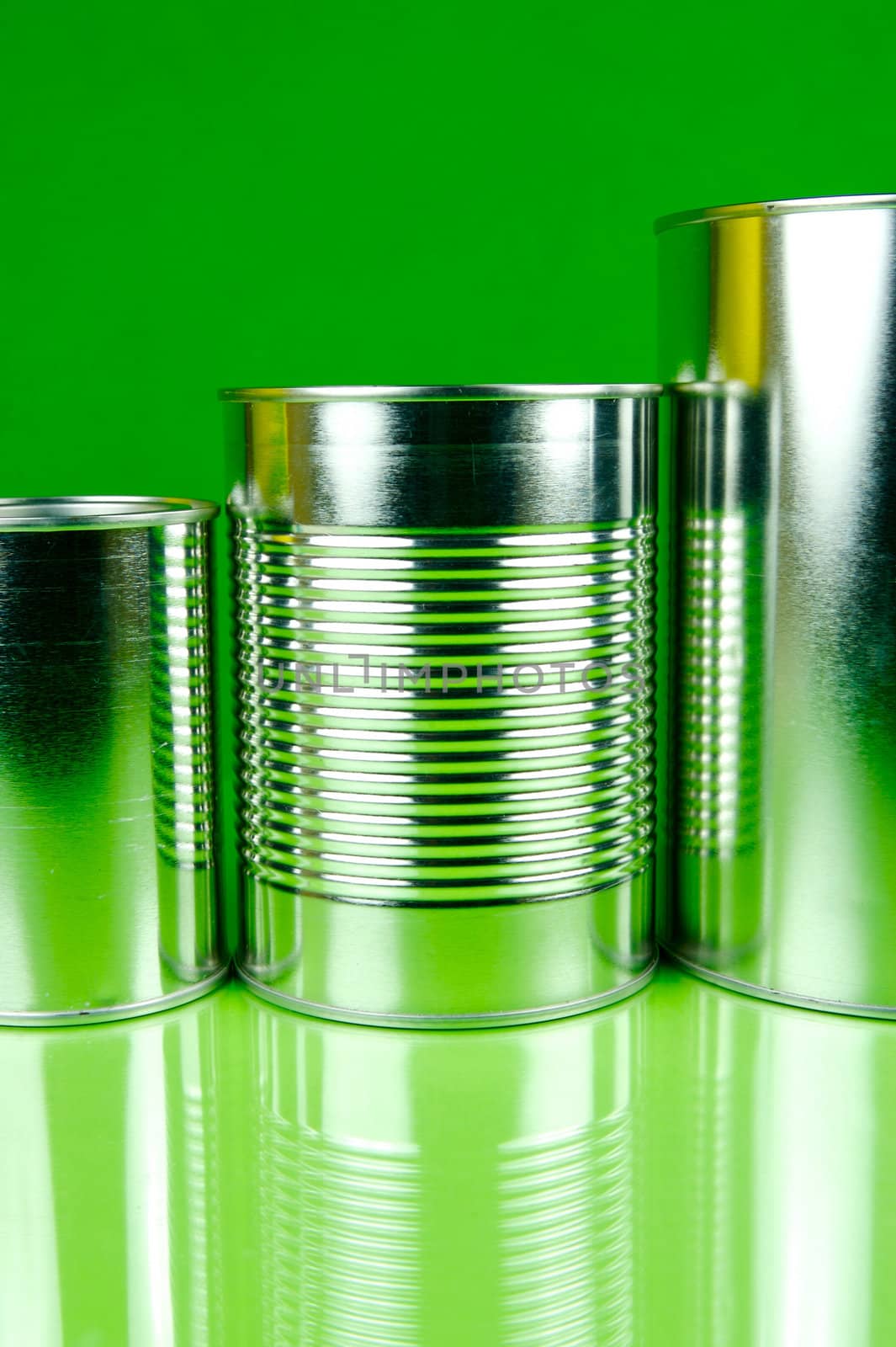 Storage tins isolated against a green background