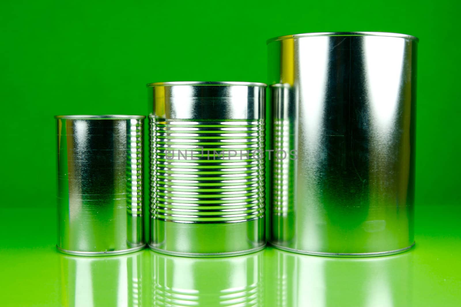 Storage tins isolated against a green background