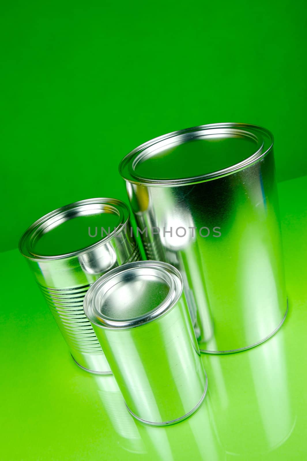 Storage tins isolated against a green background