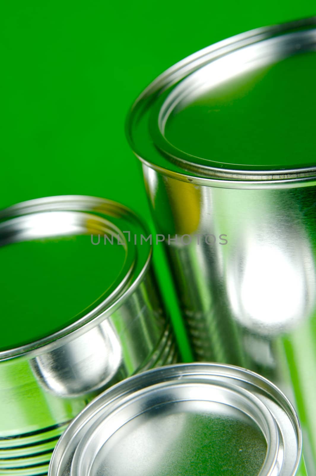 Storage tins isolated against a green background