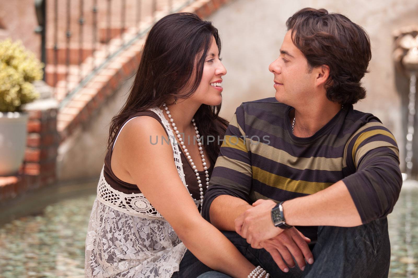 Attractive Hispanic Couple Portrait Enjoying Each Other Outdoors.