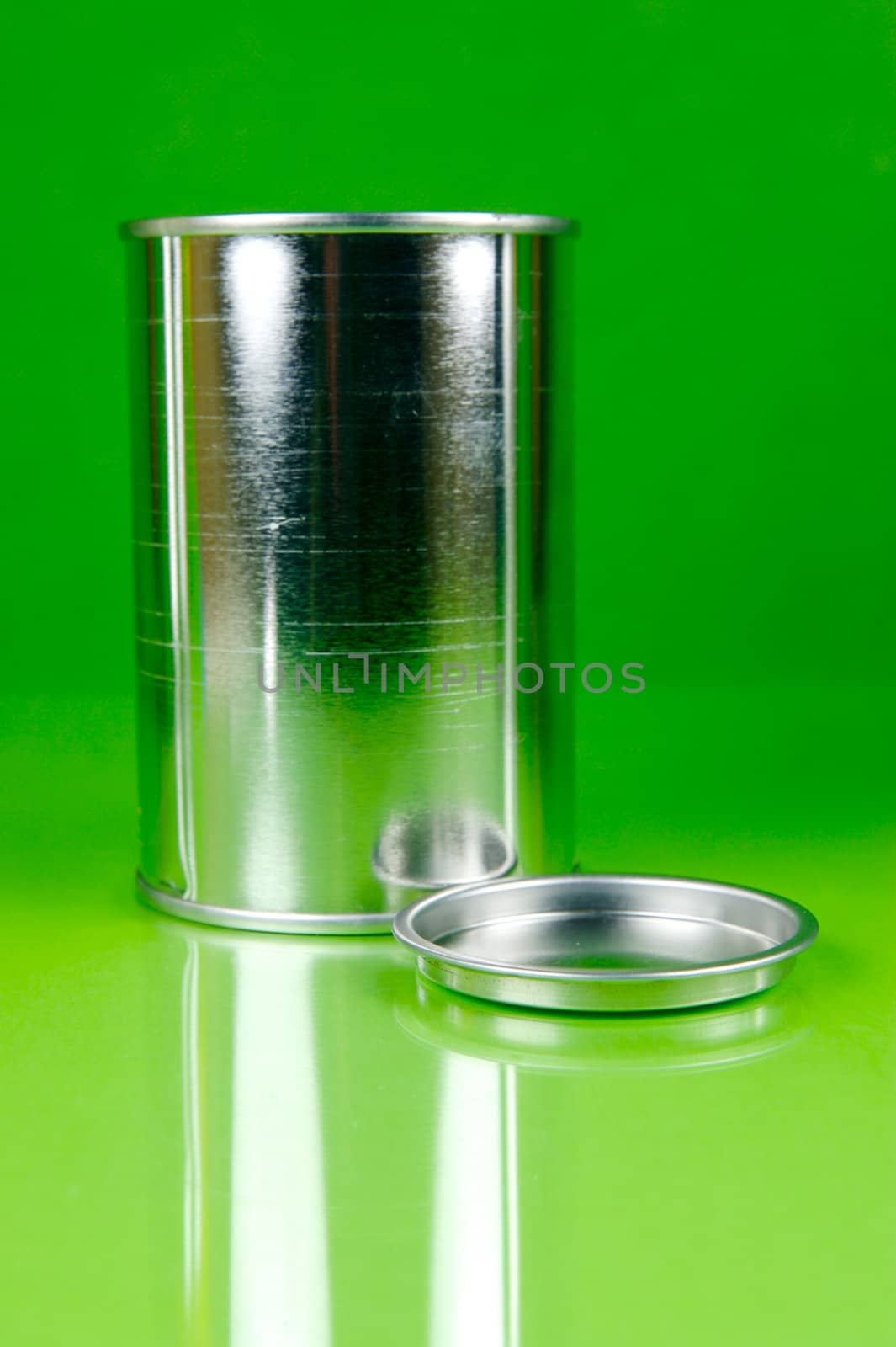 Storage tins isolated against a green background