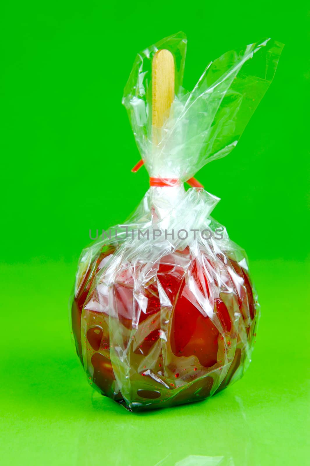 Candy apples isolated against a green background