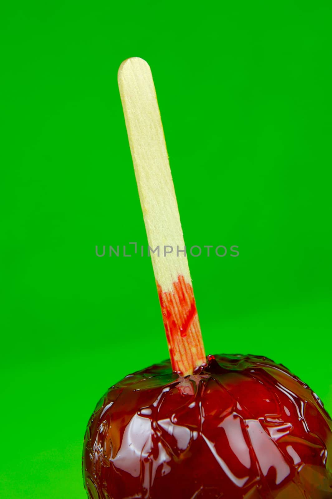 Candy apples isolated against a green background