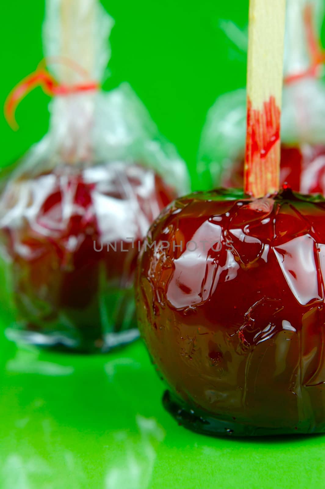 Candy apples isolated against a green background