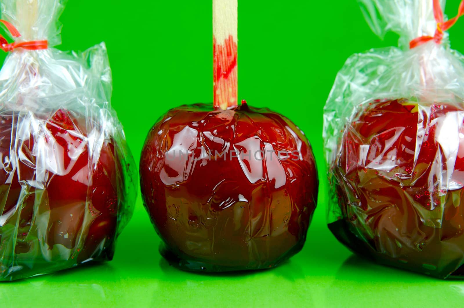 Candy apples isolated against a green background