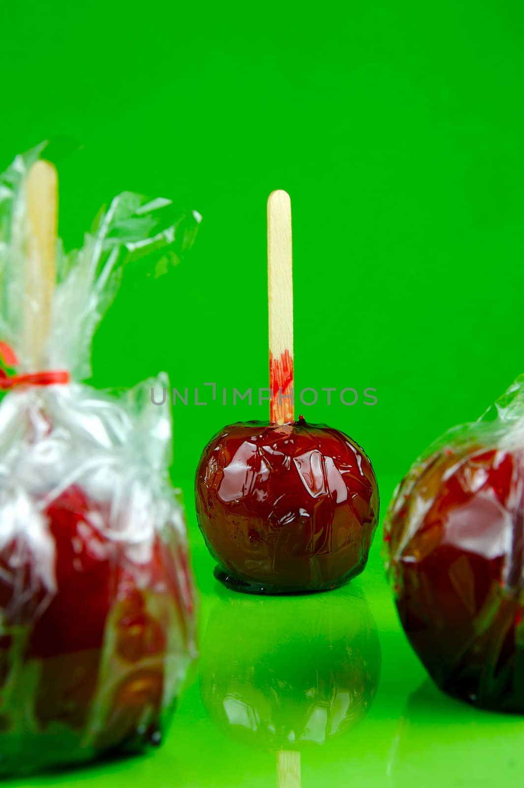 Candy apples isolated against a green background