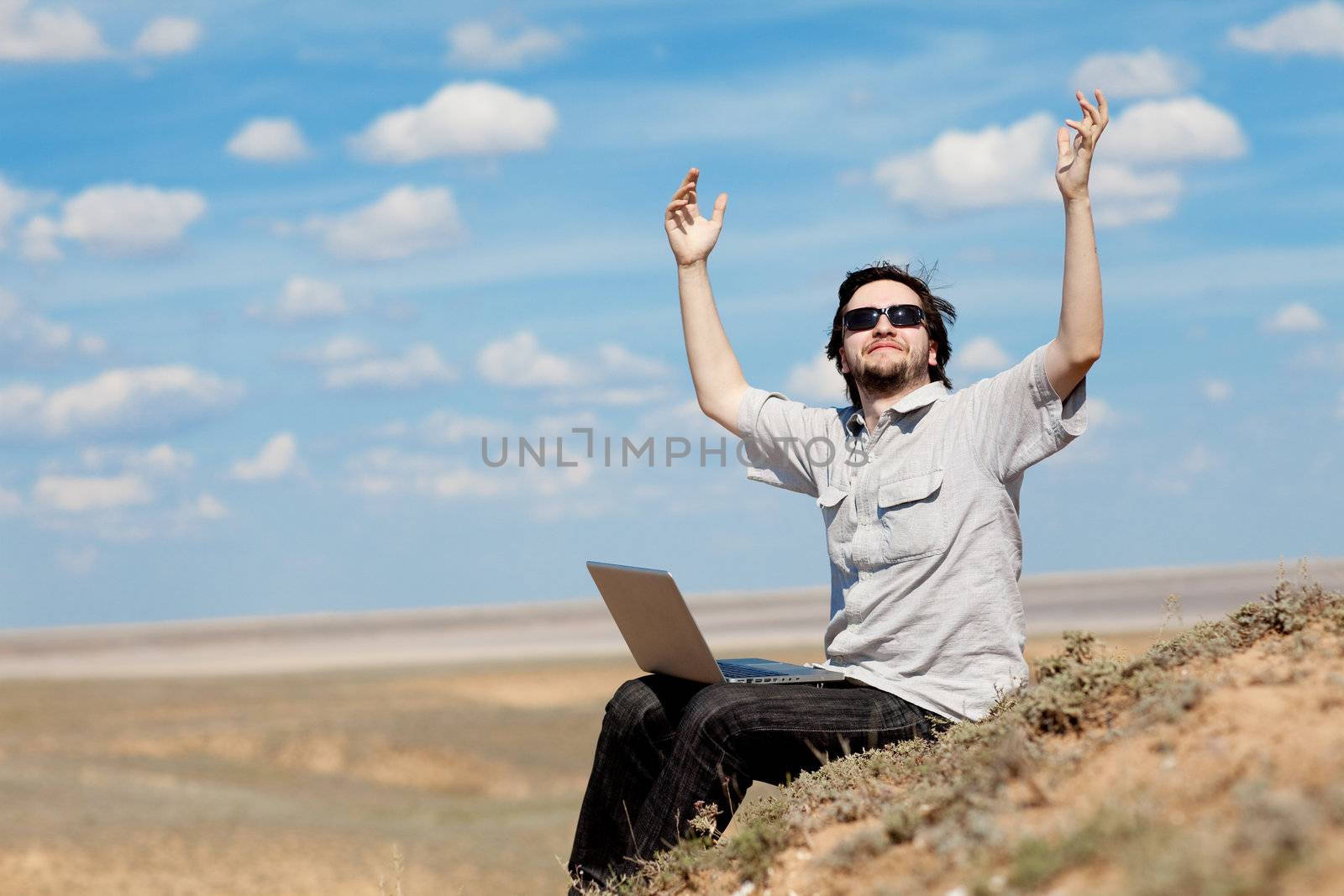 man with laptop on the mountain