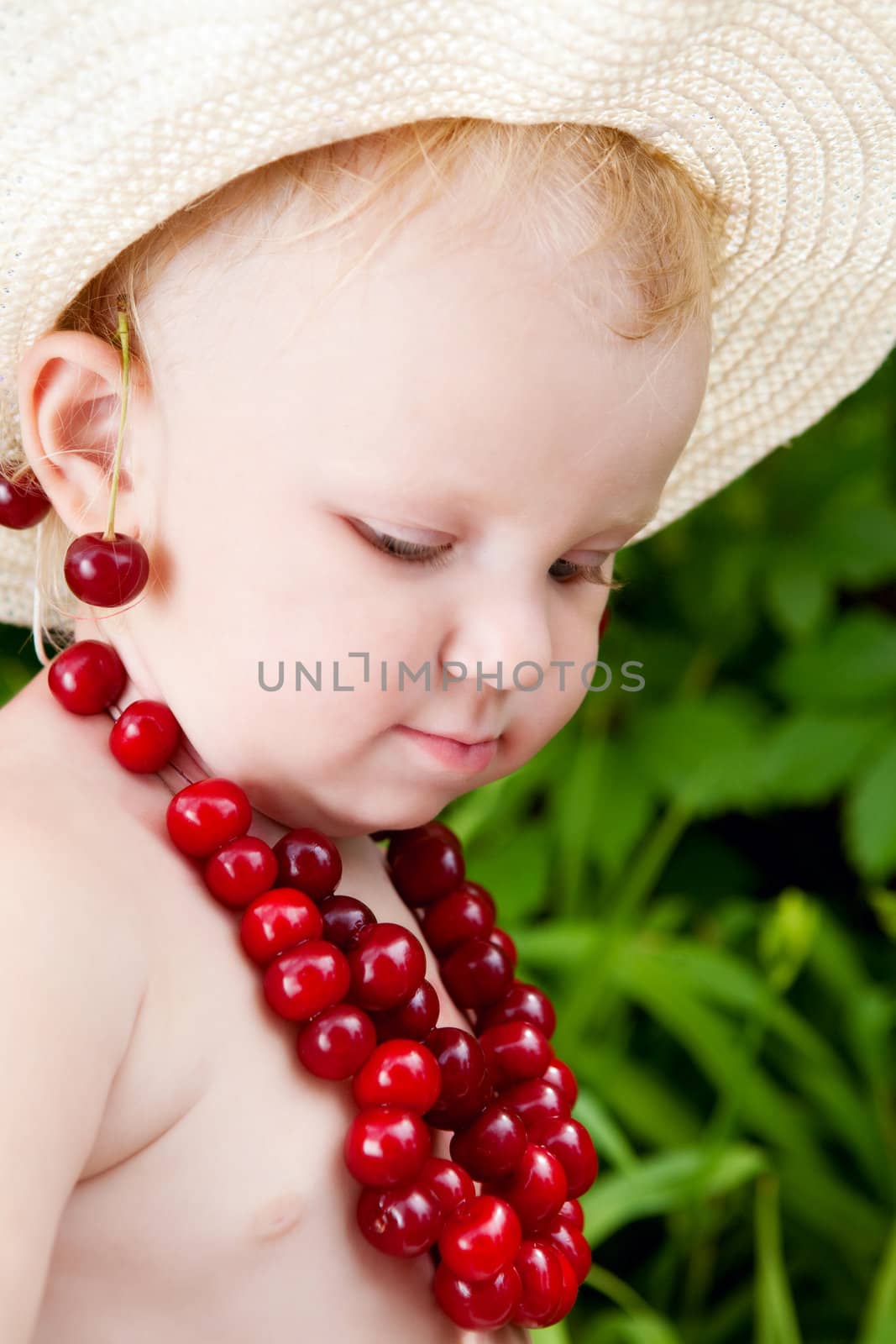 girl and cherries in green leaves background