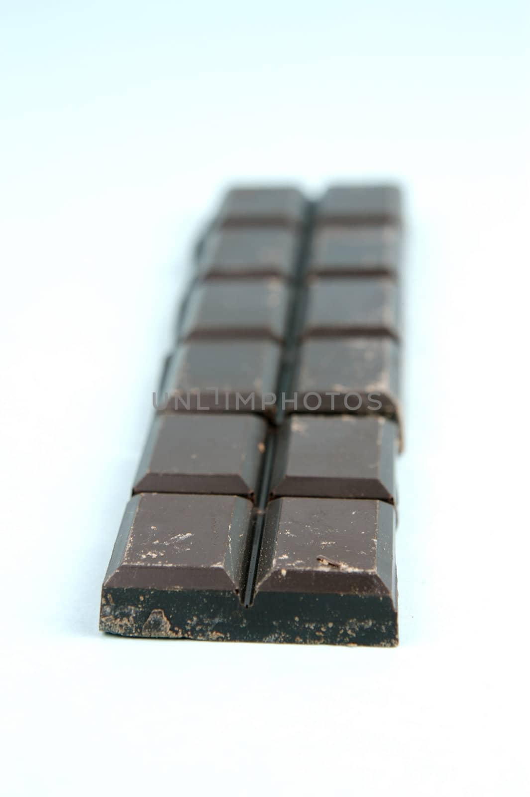 Dark Chocolate isolated against a blue background