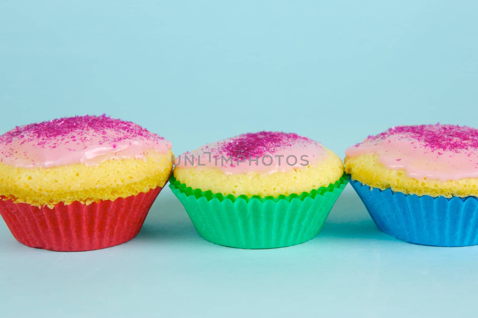 Cup cakes isolated against a blue background