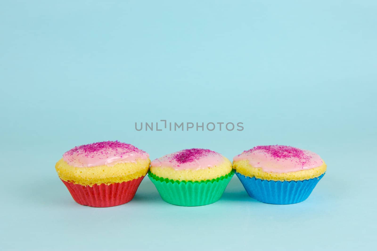 Cup cakes isolated against a blue background
