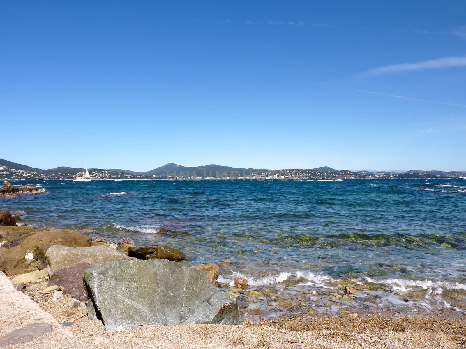 Coastline, mediterranean sea, sailing boat and little hills in the south of France, by beautiful weather