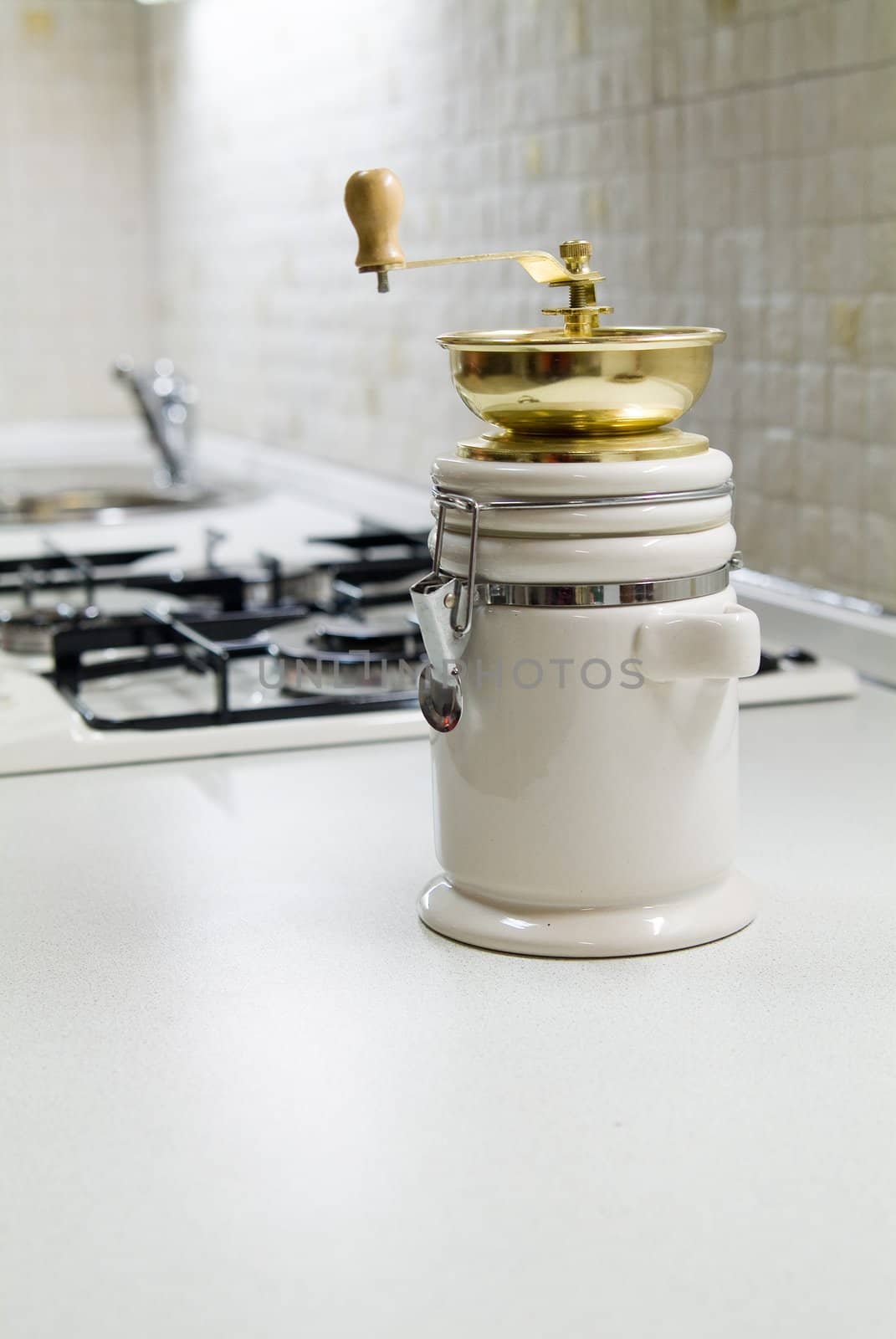 Coffe grinder near gas stove on kitchen