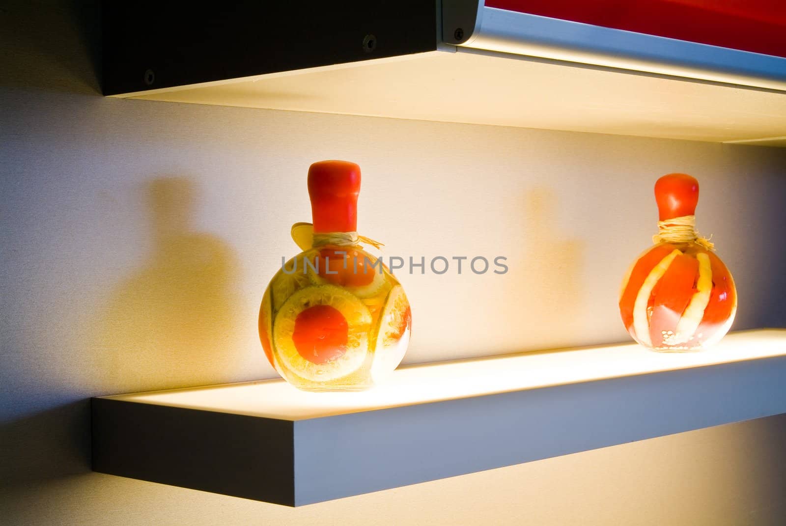 Two decorative bottles on light table on kitchen