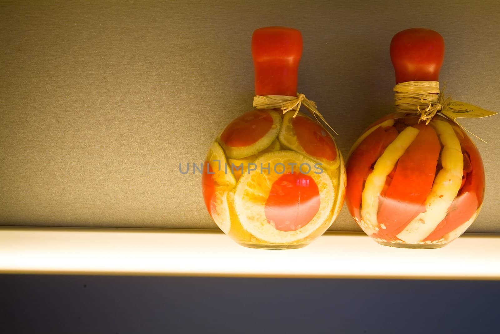 Two decorative bottles on light table on kitchen