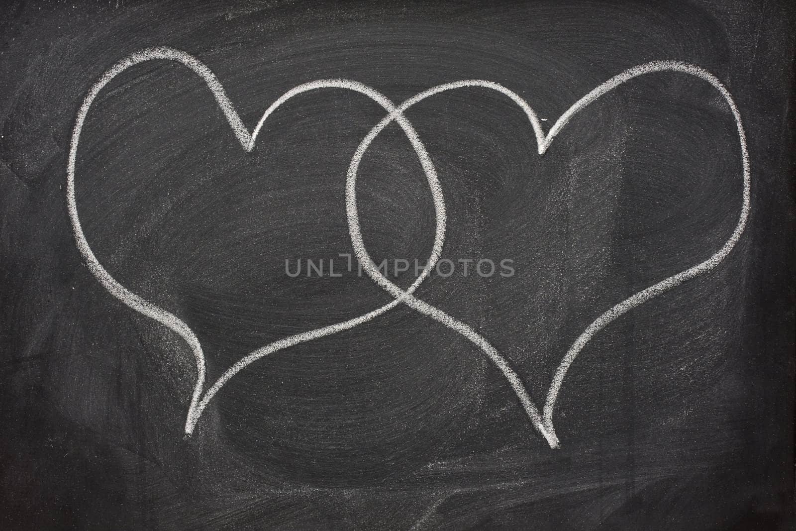two heart speech bubbles on blackboard by PixelsAway