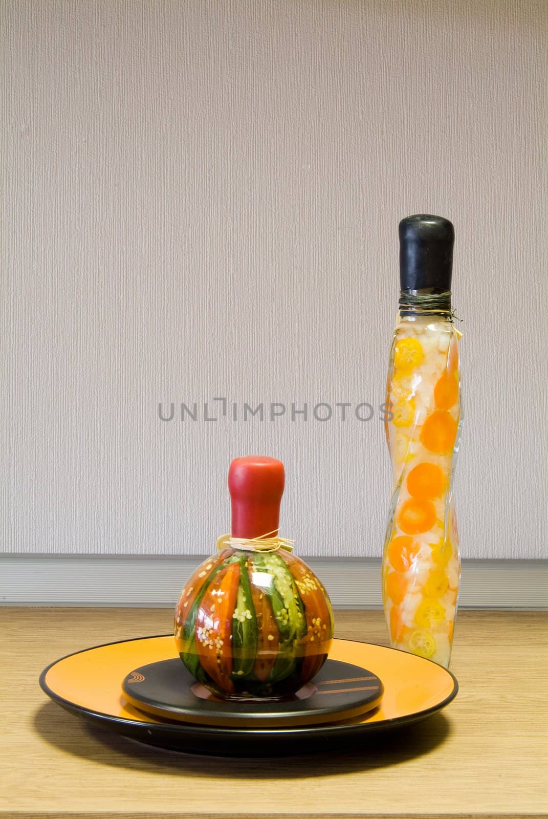 Decorative bottles and the ceramic plate on the table