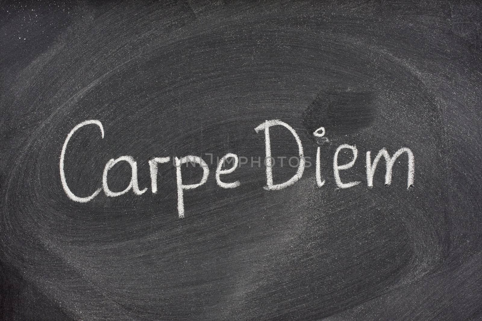Carpe Diem phrase on blackboard by PixelsAway