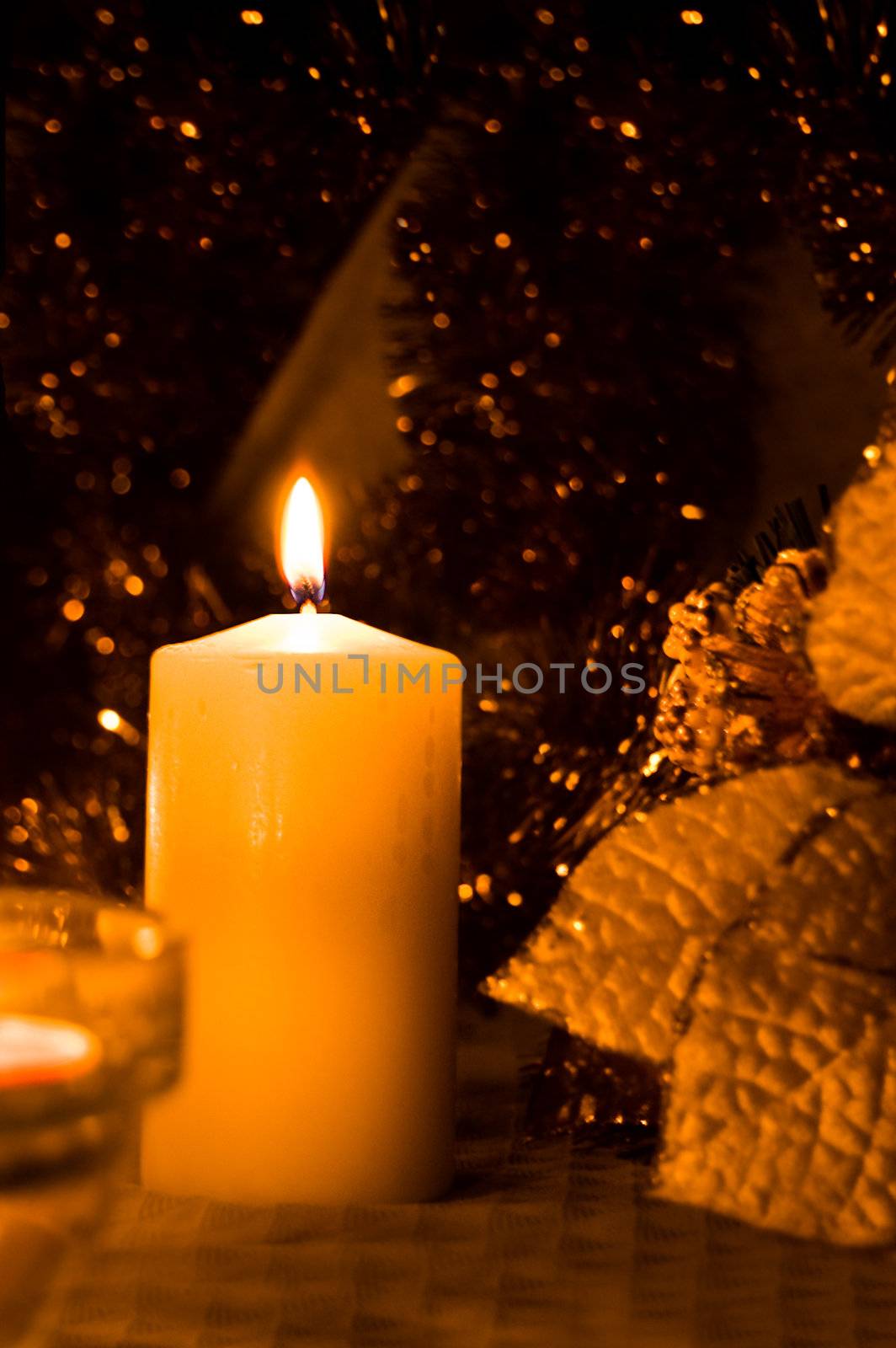 Candle lit on christmas background