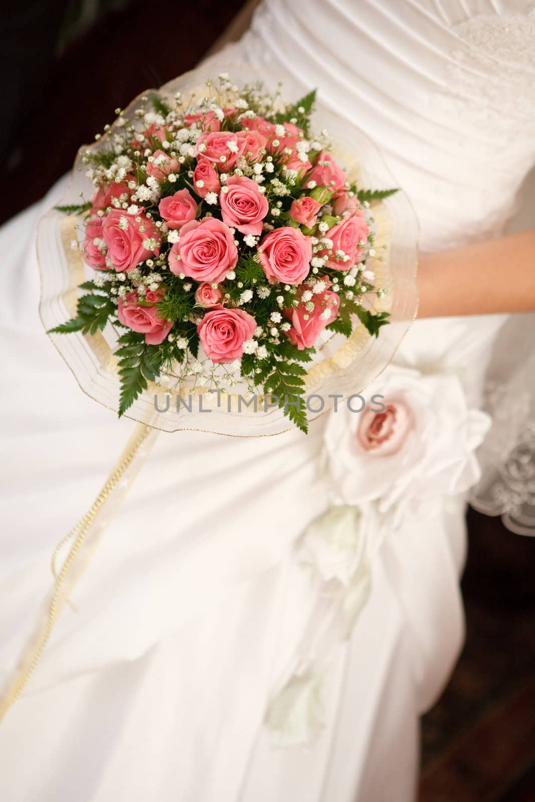 bouquet with roses in the hands of the bride